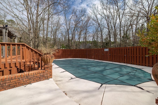 view of swimming pool featuring a fenced in pool, fence, and a patio