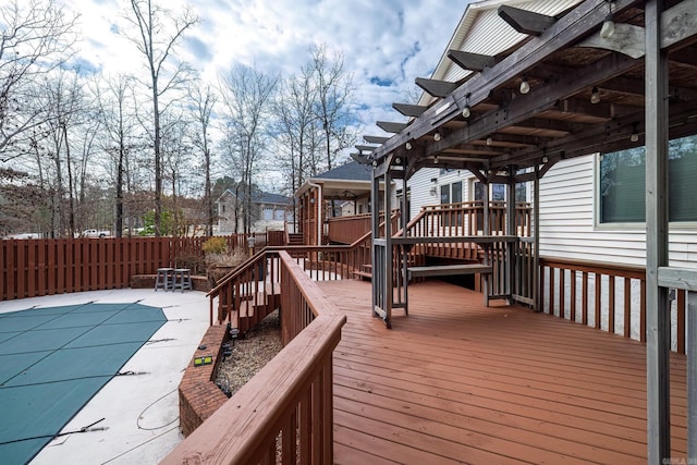 wooden terrace featuring a fenced in pool, fence, a pergola, and a patio