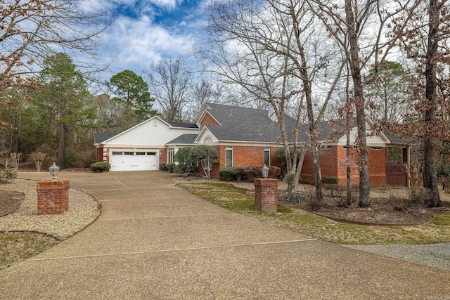 view of front of house featuring a garage, driveway, and brick siding