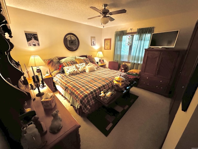 bedroom with a textured ceiling, carpet floors, and ceiling fan