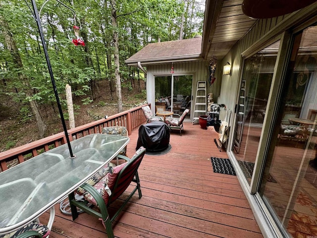 wooden deck featuring outdoor dining area