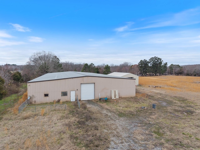 view of pole building with dirt driveway