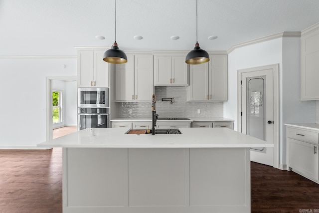 kitchen with stainless steel microwave, decorative backsplash, a sink, light countertops, and wall oven