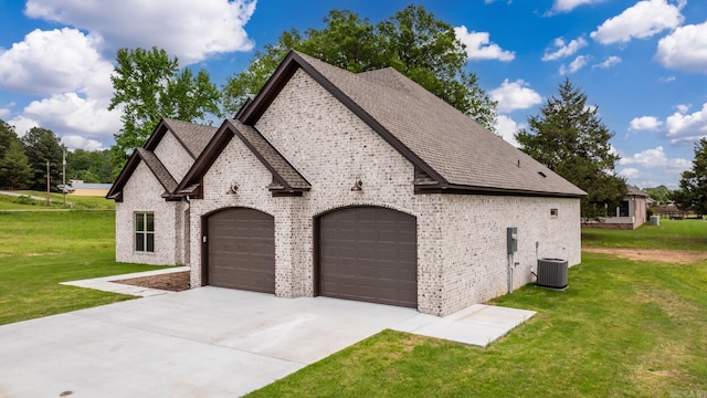 view of home's exterior featuring concrete driveway, central air condition unit, an attached garage, a lawn, and brick siding