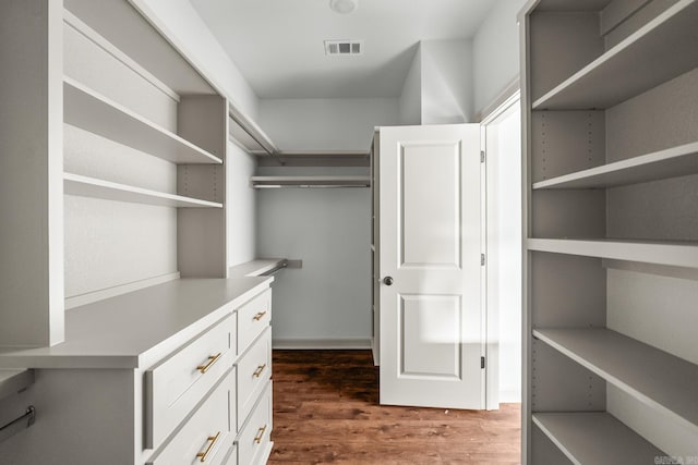 walk in closet with dark wood-style floors and visible vents