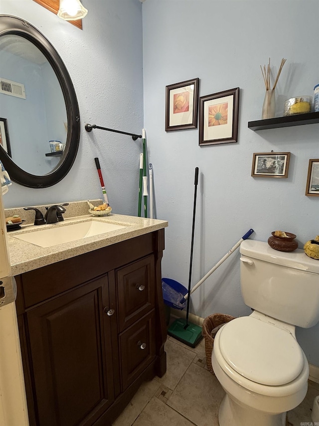 half bath featuring toilet, tile patterned flooring, visible vents, and vanity