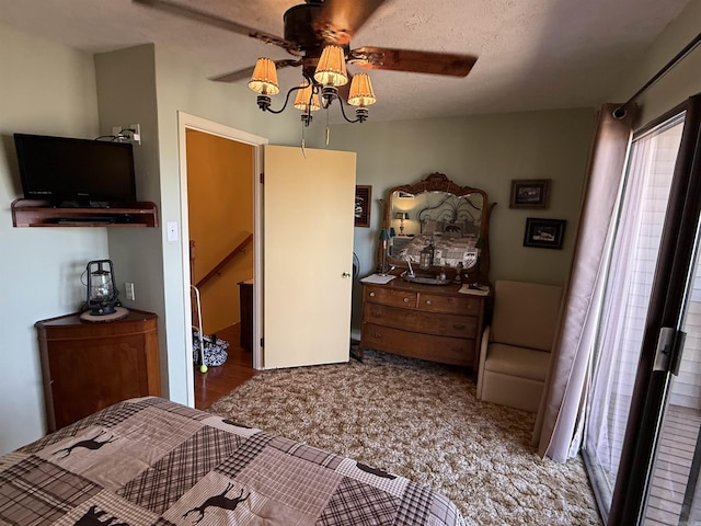 bedroom with a ceiling fan and a textured ceiling