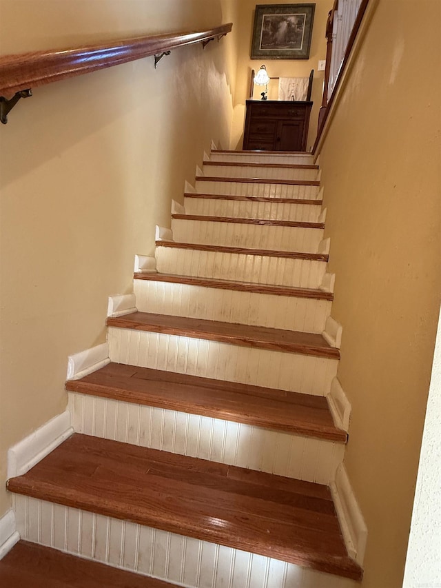 stairs with baseboards and wood finished floors