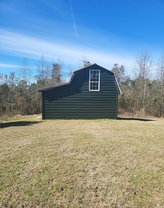 view of property exterior featuring a yard and a gambrel roof