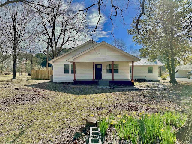 view of front of home with covered porch and fence