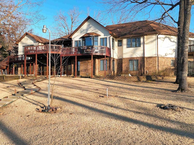 view of front of house featuring brick siding and a deck