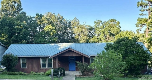 ranch-style home featuring metal roof