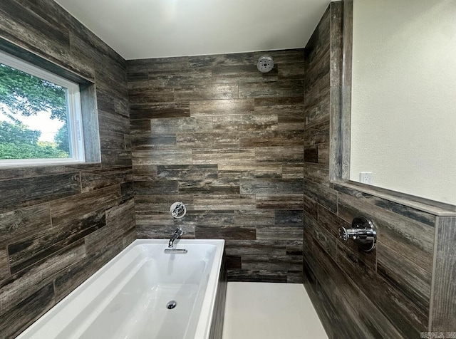 full bathroom featuring a tub to relax in and a tile shower