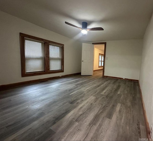 interior space featuring wood finished floors, a ceiling fan, and baseboards