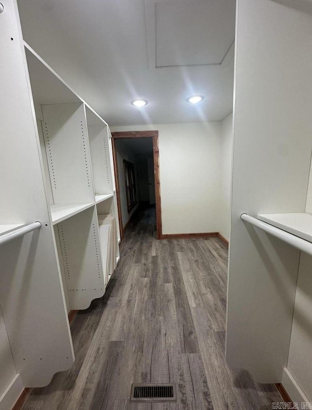 walk in closet featuring visible vents and wood finished floors