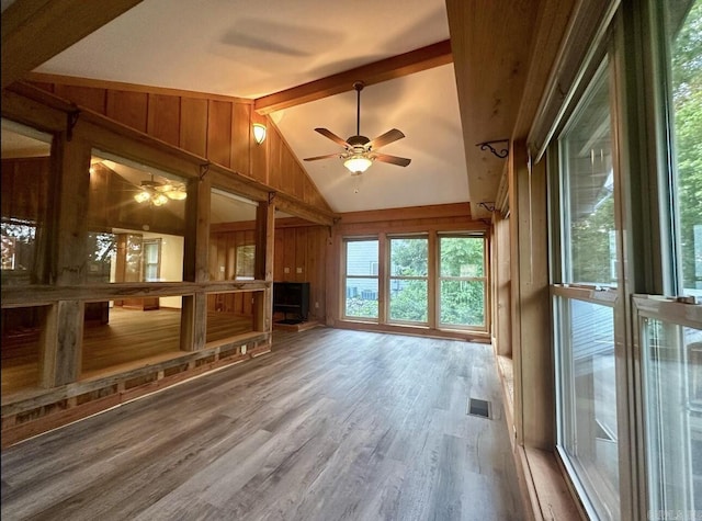 unfurnished sunroom with lofted ceiling with beams, ceiling fan, and visible vents