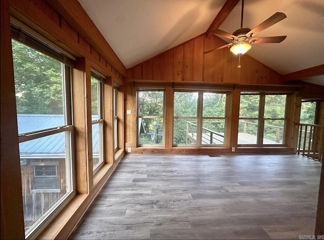 unfurnished sunroom with vaulted ceiling with beams and a ceiling fan