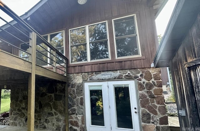 view of home's exterior featuring stone siding and a deck