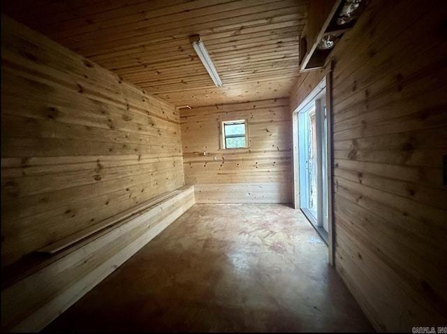 bonus room featuring concrete floors, wooden ceiling, and wood walls