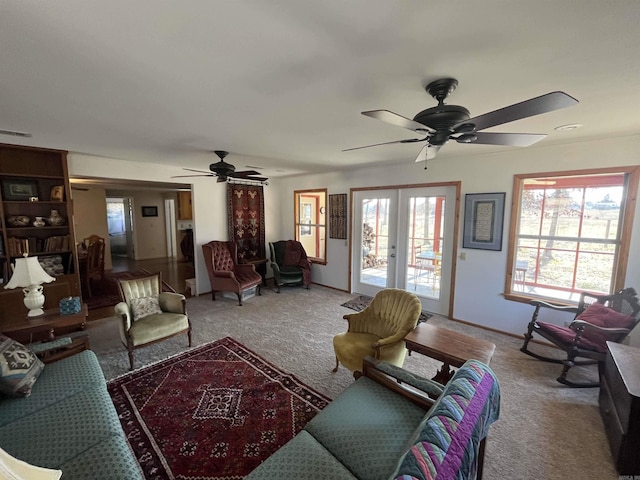 carpeted living area with french doors, a healthy amount of sunlight, ceiling fan, and visible vents