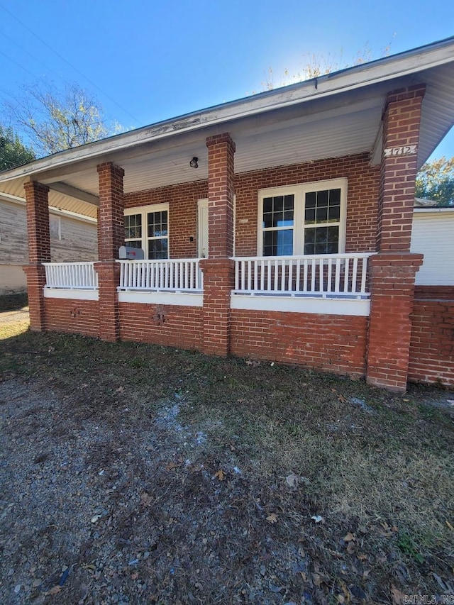 view of front of property with a porch and brick siding