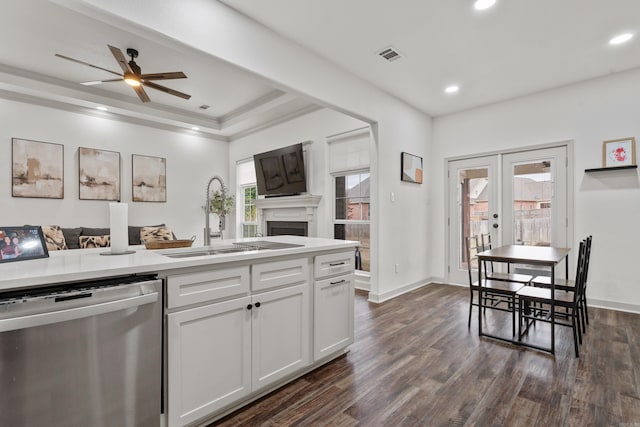 kitchen featuring dark wood finished floors, open floor plan, a sink, and stainless steel dishwasher