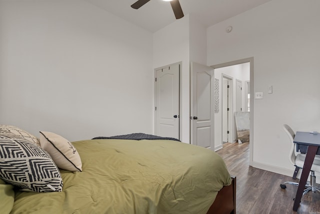 bedroom featuring ceiling fan, baseboards, and wood finished floors