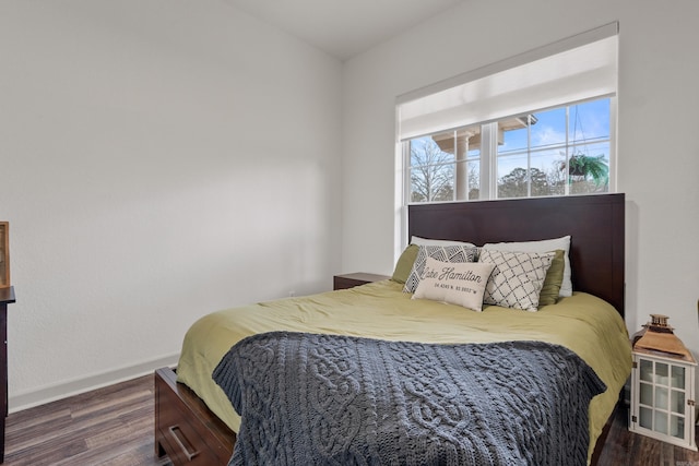 bedroom featuring wood finished floors and baseboards