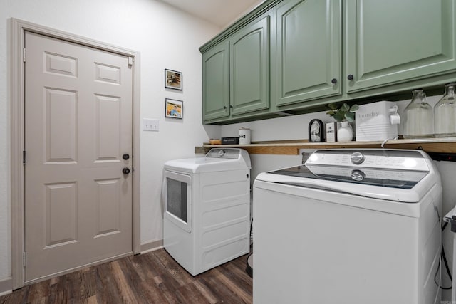 laundry room featuring dark wood-style flooring, cabinet space, and washer and clothes dryer