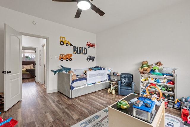 bedroom with wood finished floors, a ceiling fan, and baseboards