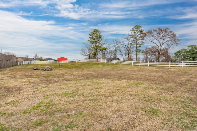 view of yard with a rural view and fence