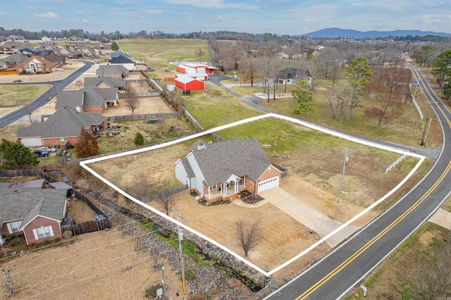 drone / aerial view featuring a residential view and a mountain view