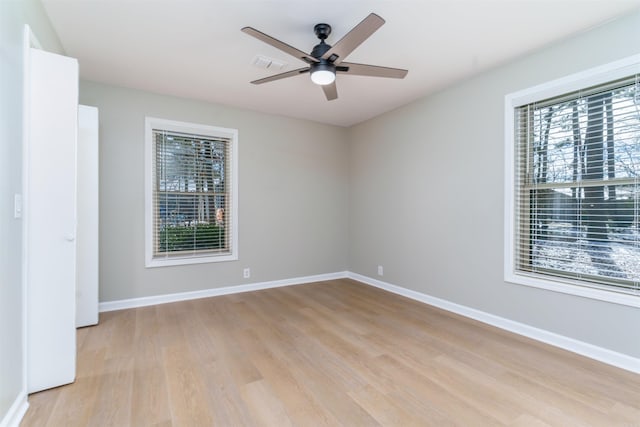 unfurnished room with light wood-style floors, ceiling fan, and baseboards