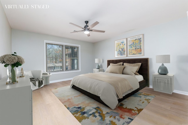 bedroom featuring light wood-style floors, baseboards, and a ceiling fan