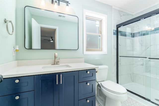 bathroom featuring toilet, a shower stall, visible vents, and vanity