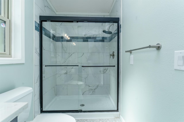 bathroom featuring a shower stall and toilet