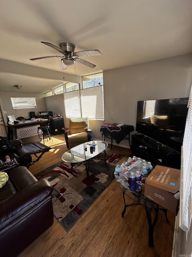 living room featuring a ceiling fan and wood finished floors