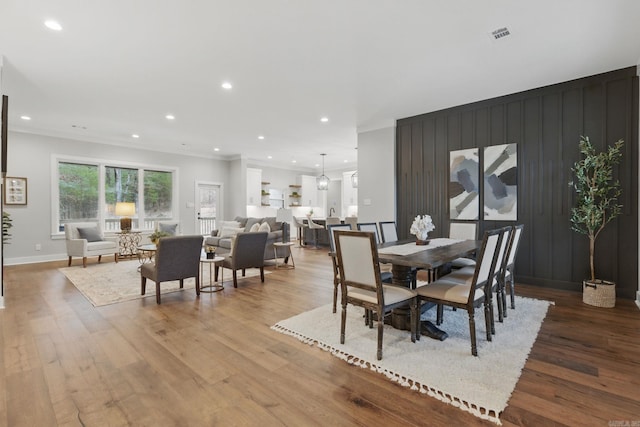 dining area featuring ornamental molding, wood finished floors, and recessed lighting