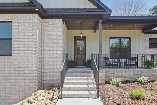 19020 Waterview Meadow Ln, Roland, AR 72135 - view of exterior entry featuring covered porch, board and batten siding, and brick siding
