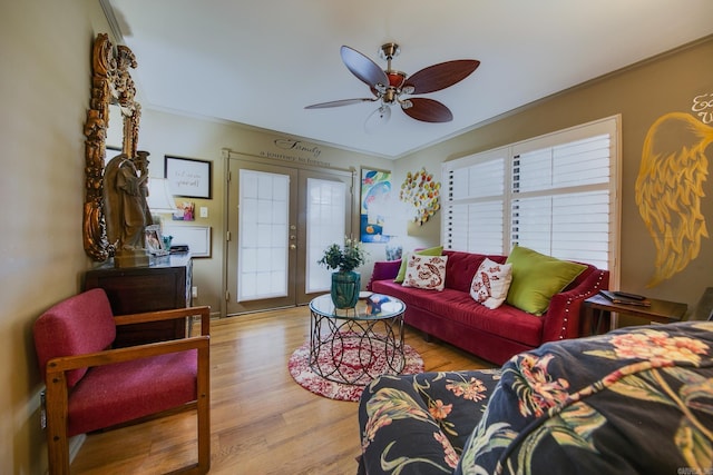 living room with ceiling fan, french doors, crown molding, and wood finished floors