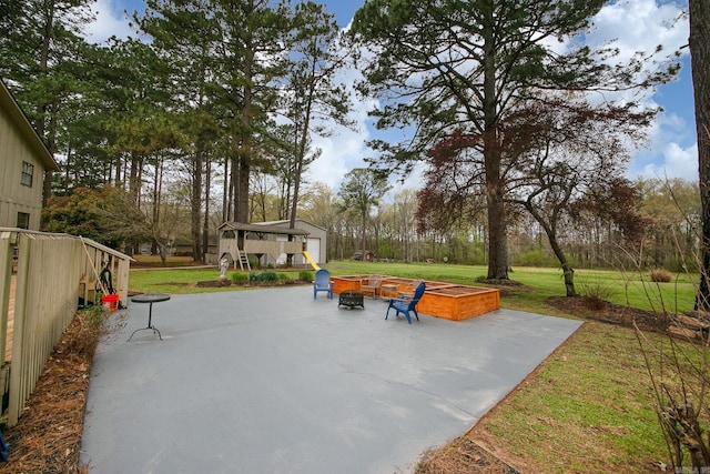 view of patio with an outdoor fire pit and an outdoor structure