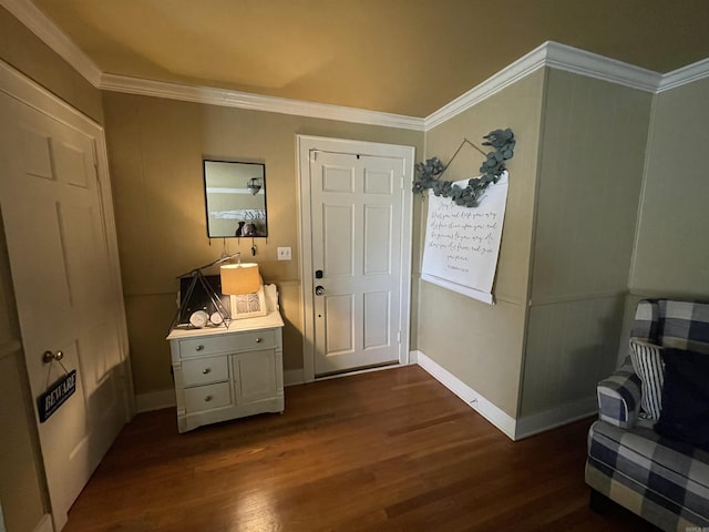 foyer entrance featuring crown molding, dark wood finished floors, and baseboards