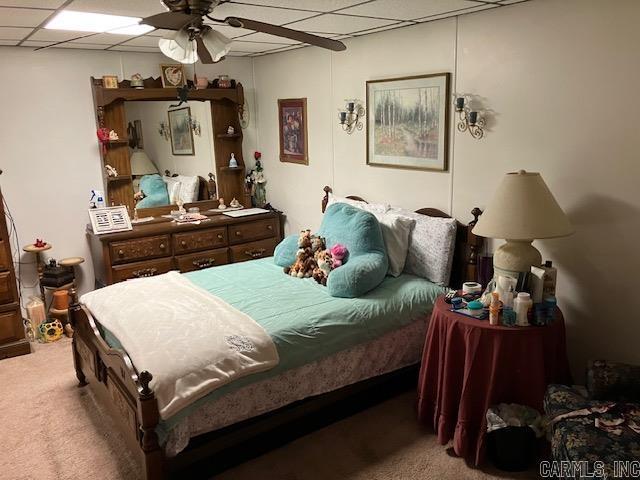 bedroom featuring carpet flooring and a paneled ceiling