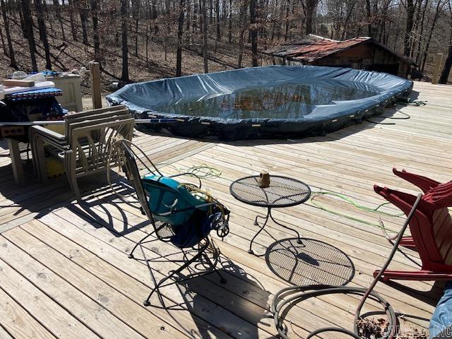 wooden deck with a forest view