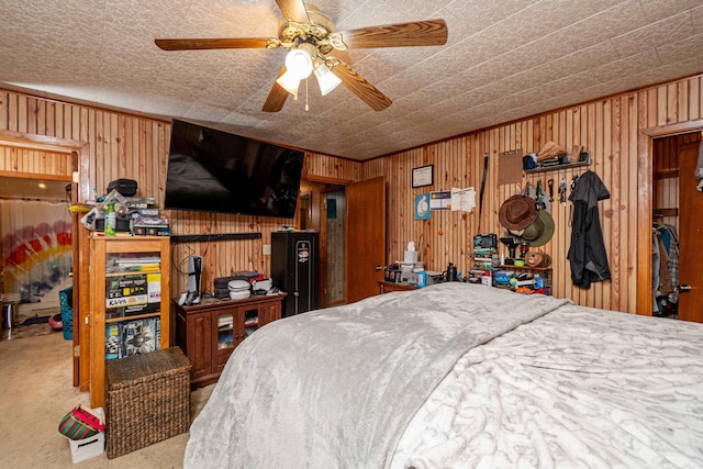 bedroom featuring wood walls and carpet flooring