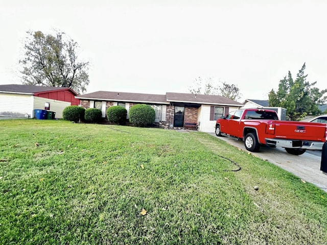 ranch-style home featuring brick siding and a front lawn