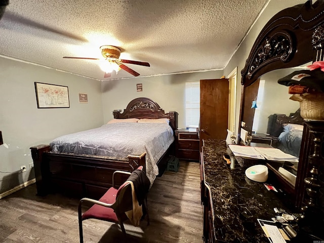 bedroom with ceiling fan, a textured ceiling, and wood finished floors