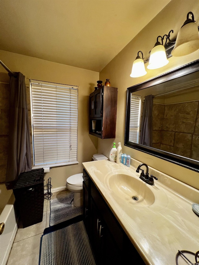 bathroom featuring tile patterned flooring, baseboards, vanity, and toilet