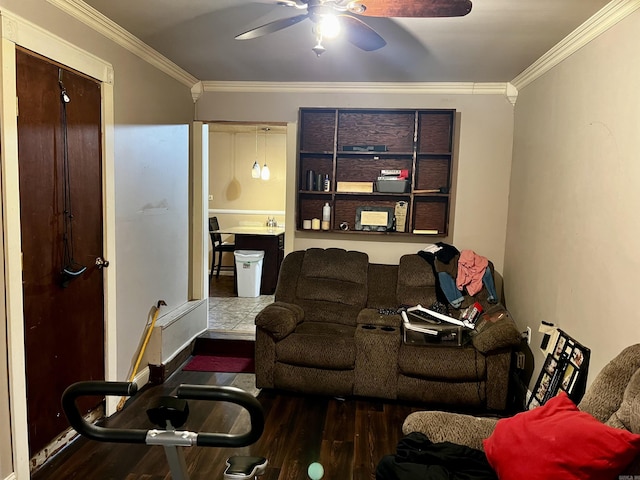 living room with ceiling fan, ornamental molding, and wood finished floors