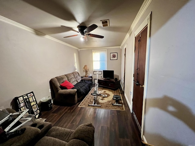 living room with a ceiling fan, visible vents, crown molding, and wood finished floors